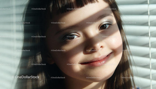 Closeup of a smiling girl with sunlight and shadows