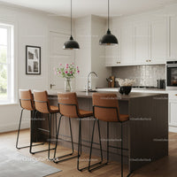 Bright Modern Kitchen with Brown Leather Bar Stools and White Cabinets