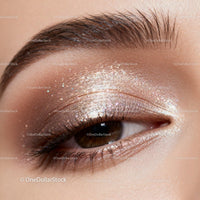 Closeup of shimmering gold eyeshadow on closed eyelid
