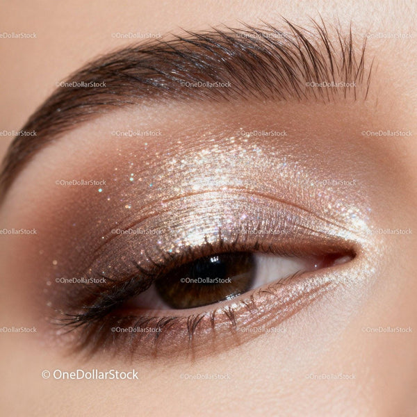 Closeup of shimmering gold eyeshadow on closed eyelid