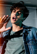 Young man expressing emotion with raised hand gesture