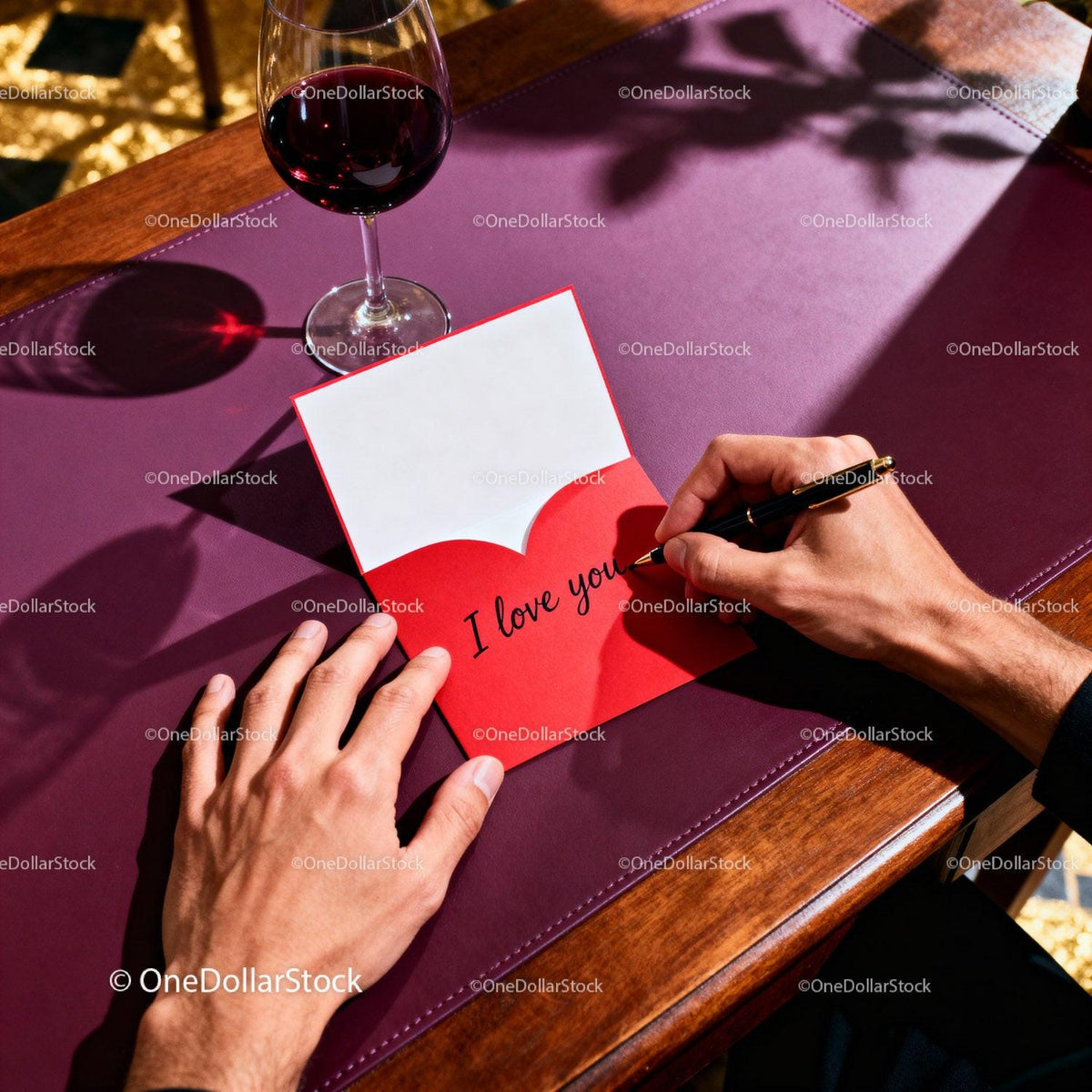 Man Writing I Love You on Valentine Card at Table