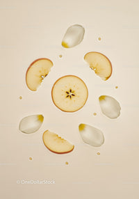 Apple slices and white petals floating in milky water