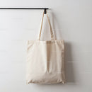Empty Natural Cotton Tote Bag Hanging on Wall Hook