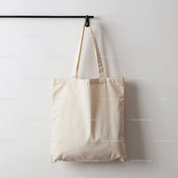 Empty Natural Cotton Tote Bag Hanging on Wall Hook