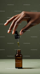 Hand Holding Glass Dropper and Amber Bottle for Natural Skincare