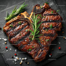 Gourmet Grilled Steak with Rosemary on Black Slate Plate