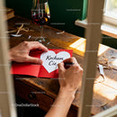 Writing a heartfelt love note with red wine on wooden desk
