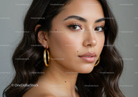 Portrait of a Beautiful Woman with Brown Eyes and Gold Earrings