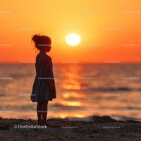Silhouette of a Child at Sunset by the Ocean Shore