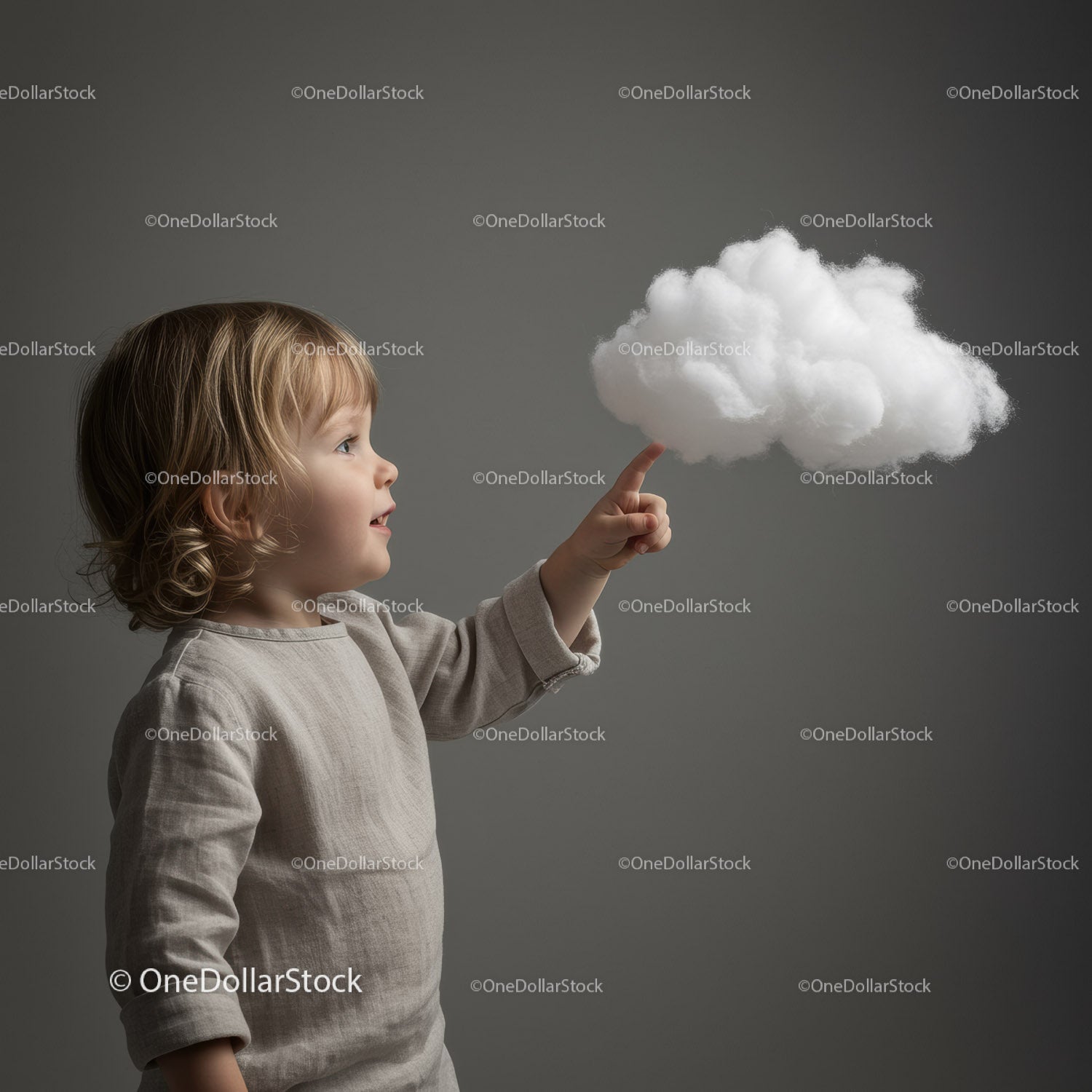 Curious toddler reaching out to fluffy cloud model