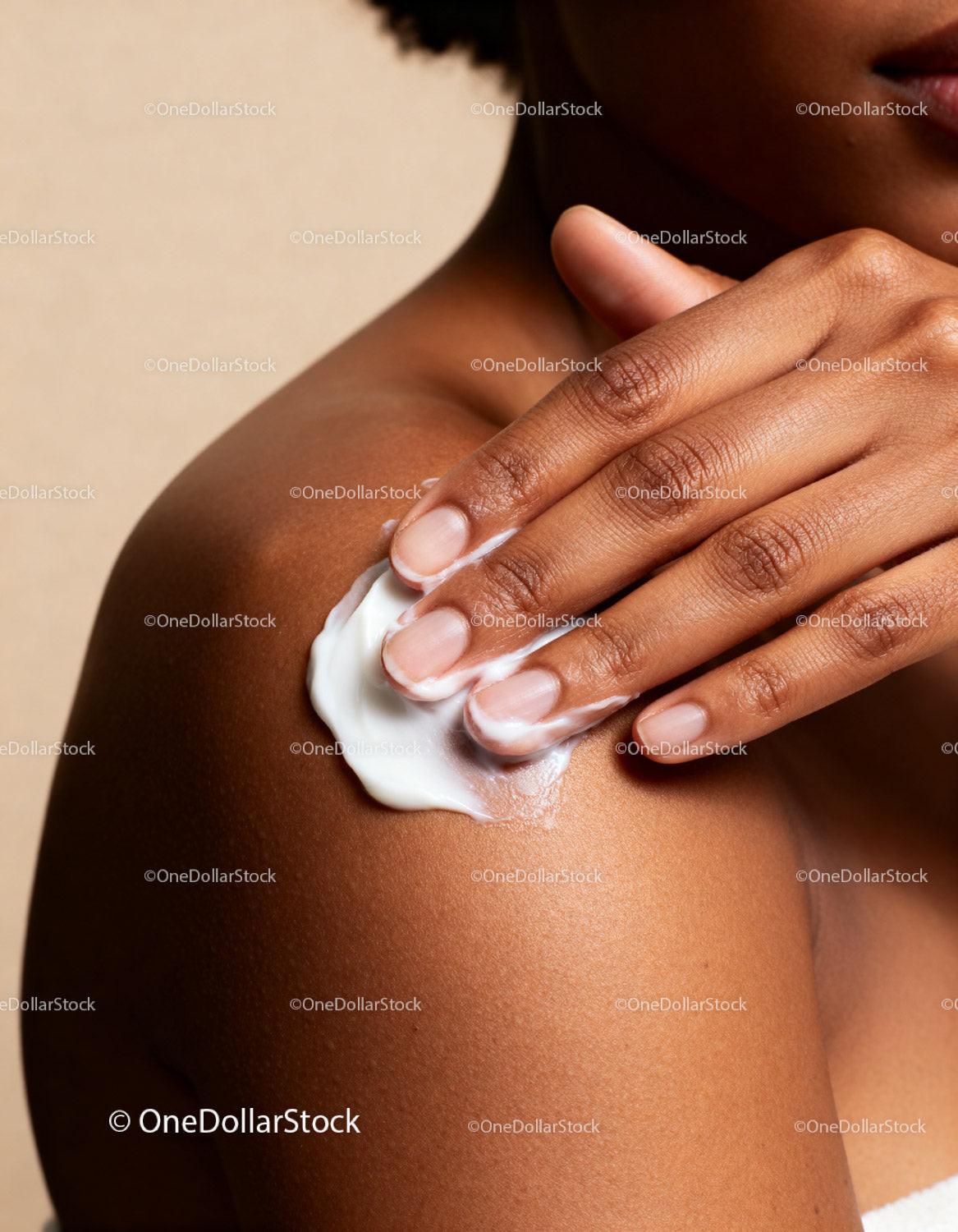 Close-up of Woman Applying Moisturizer on Shoulder