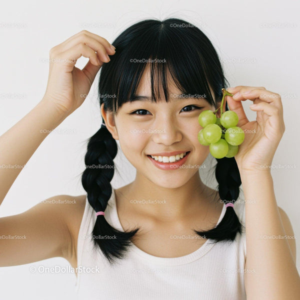 Young Girl with Green Grapes Smiling Joyfully in Natural Light