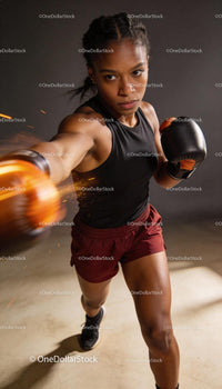 Focused woman boxer delivering a powerful punch