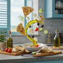 Fresh Mediterranean ingredients flying into white bowl