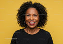 Professional Portrait of Smiling African American Woman with Curly Hair Against Yellow Background