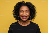 Professional Portrait of Smiling African American Woman with Curly Hair Against Yellow Background