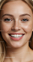 Close up of smiling young woman with natural freckles