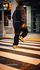 Casual urban style man crossing street at night