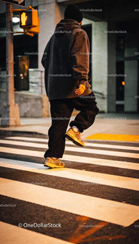 Casual urban style man crossing street at night