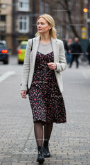 Stylish Woman Walking on City Street in Autumn Dress and Black Boots