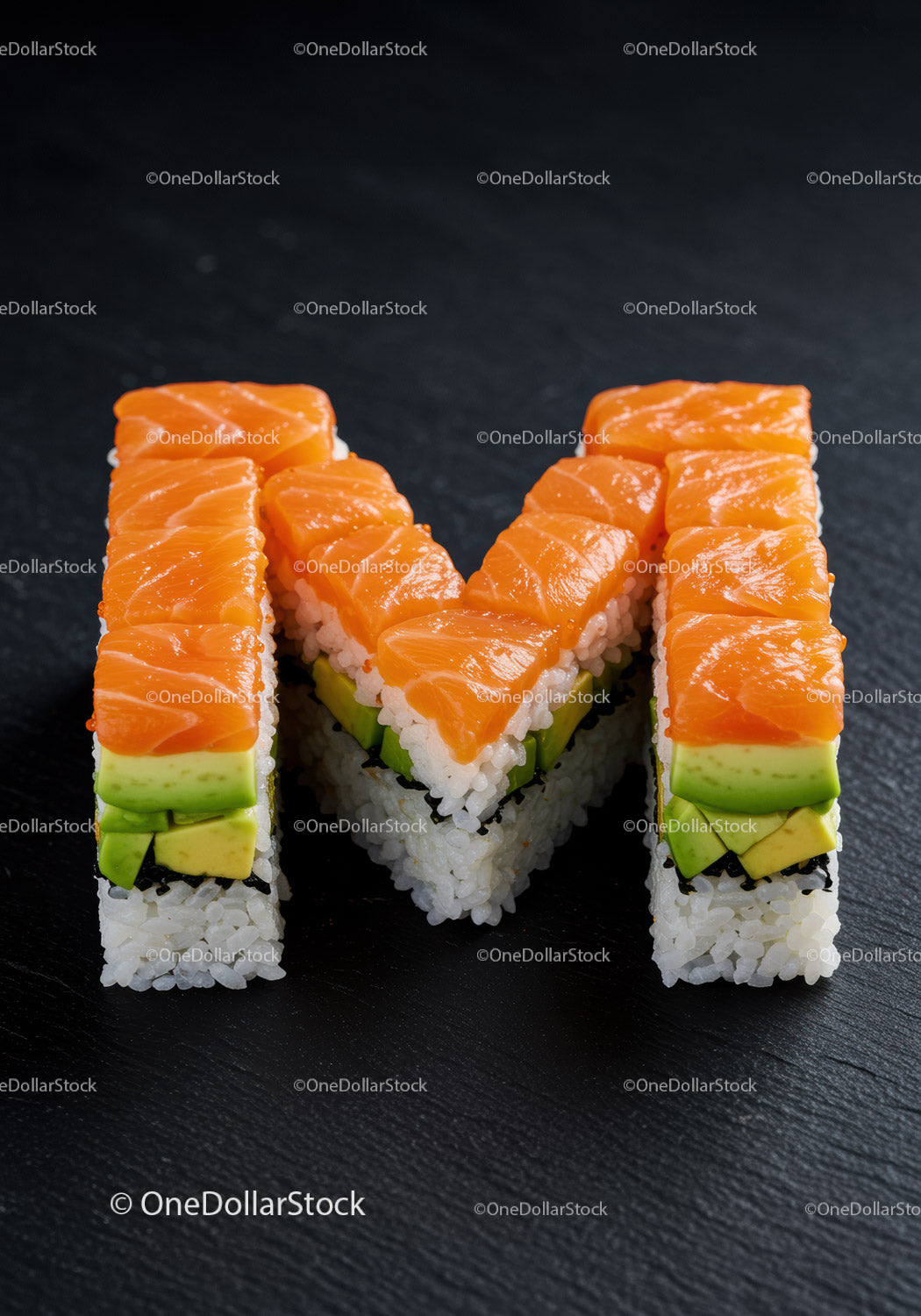 Creative sushi rolls shaped as the letter M with salmon
