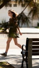 Young girl walking confidently on sunny sidewalk