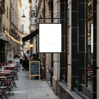 Empty cafe street with blank hanging signboard in city
