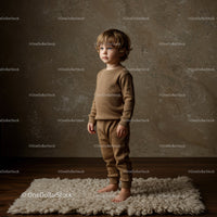Young toddler boy standing barefoot on cozy rug indoors