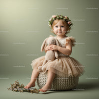 Toddler girl with flower crown hugging plush bunny