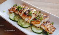 Grilled Fish Fillet with Cucumber and Herbs on White Plate