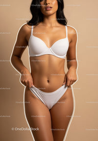 Elegant Woman in White Lingerie Beautifully Posed Against Beige Background