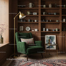 Cozy reading nook with green armchair and wooden shelves