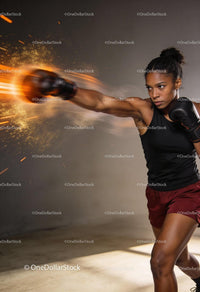 Focused woman boxing with dynamic energy and power