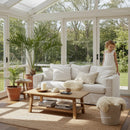 Cozy sunlit living room with greenery and child