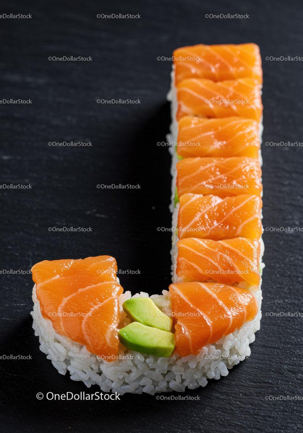 Sushi shaped as letter J with fresh salmon and avocado