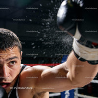 Focused young boxer throwing a powerful punch