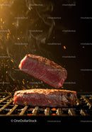 Tender steak grilling with glowing sparks and smoke