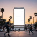 Urban sunset street scene with blank billboard and pedestrians