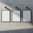 Three Blank Vertical Frames on Concrete Wall with Lighting