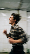 Young man expressing intense emotion in motion blur
