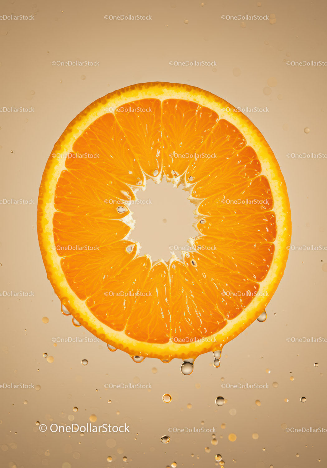 Fresh orange slice suspended in water with bubbles