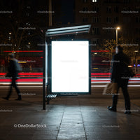 Illuminated Empty Bus Stop Advertising Panel at Night