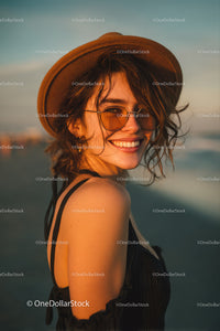 Smiling Woman in Sunglasses on Beach During Sunset