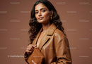 Elegant Woman in Brown Leather Coat with Gold Accessories