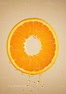 Fresh orange slice dripping juice in soft light