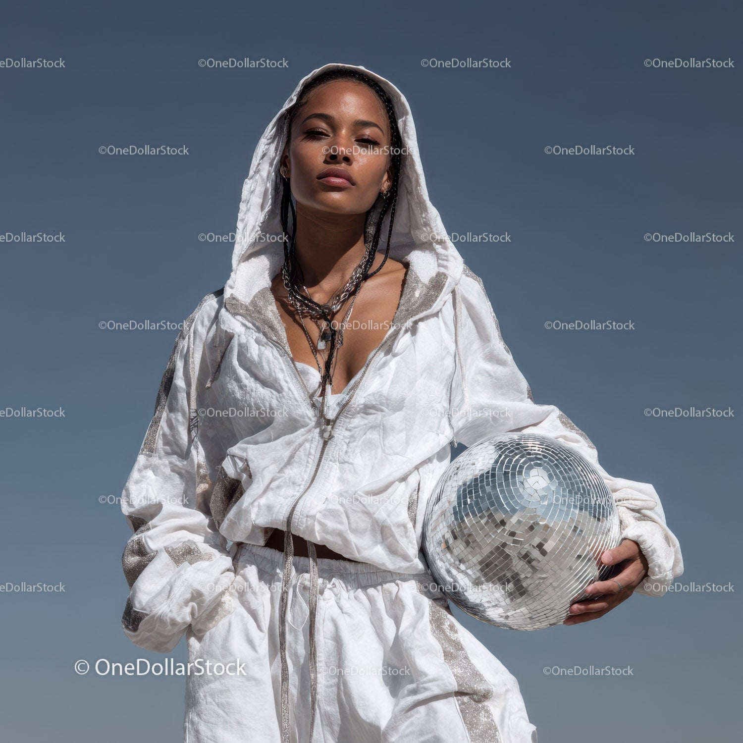 Stylish Woman in Metallic Outfit Holding Disco Ball for Modern Fashion