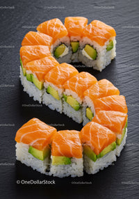 Sushi rolls arranged in a sleek S shape with fresh salmon