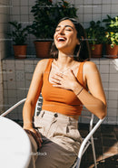 Joyful Woman Laughing in a Bright Outdoor Setting