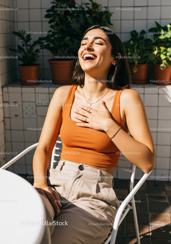 Joyful Woman Laughing in a Bright Outdoor Setting